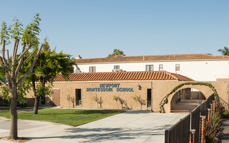 A building with a large lawn in front of it.