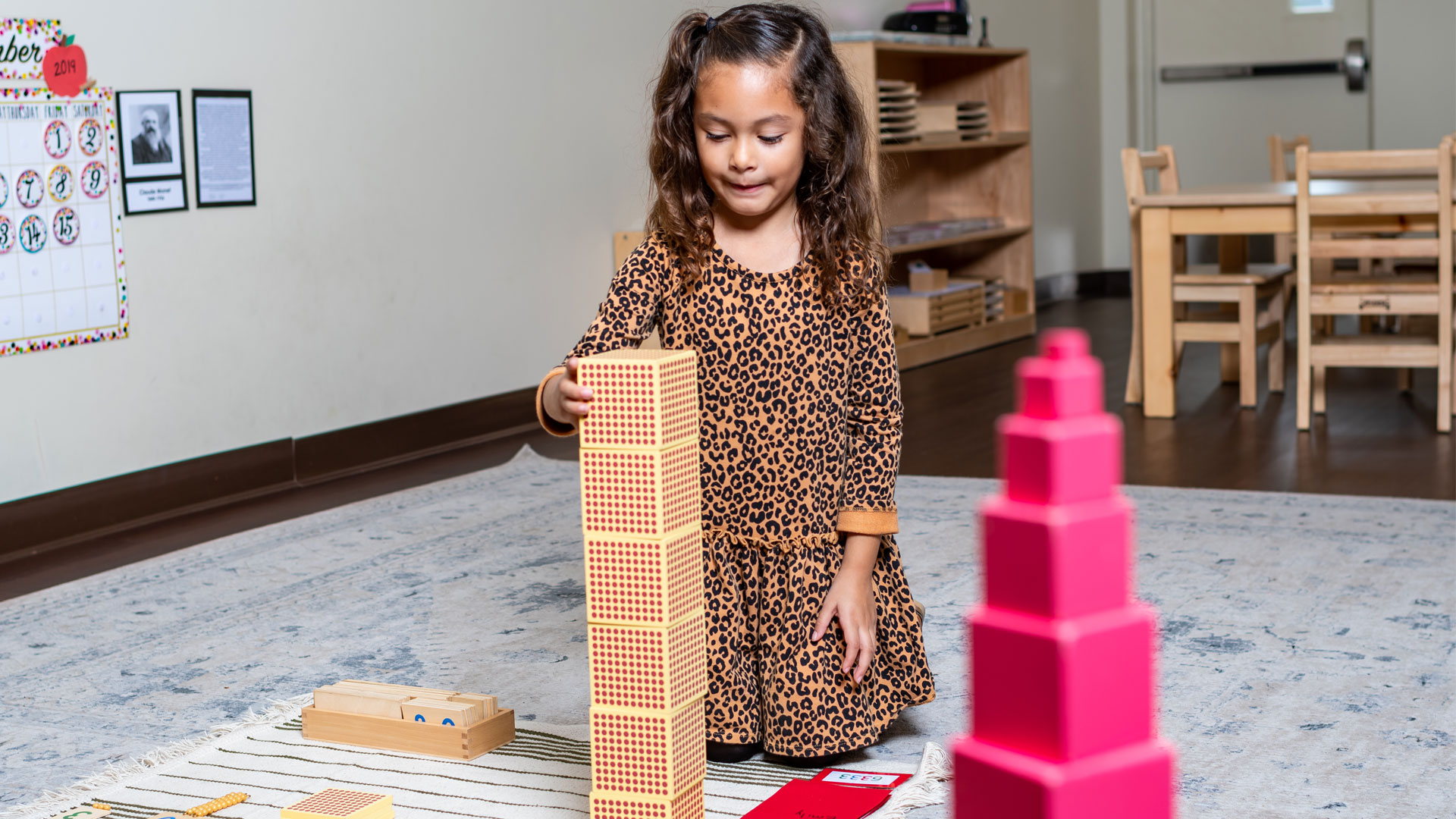 A little girl playing wooden blocks
