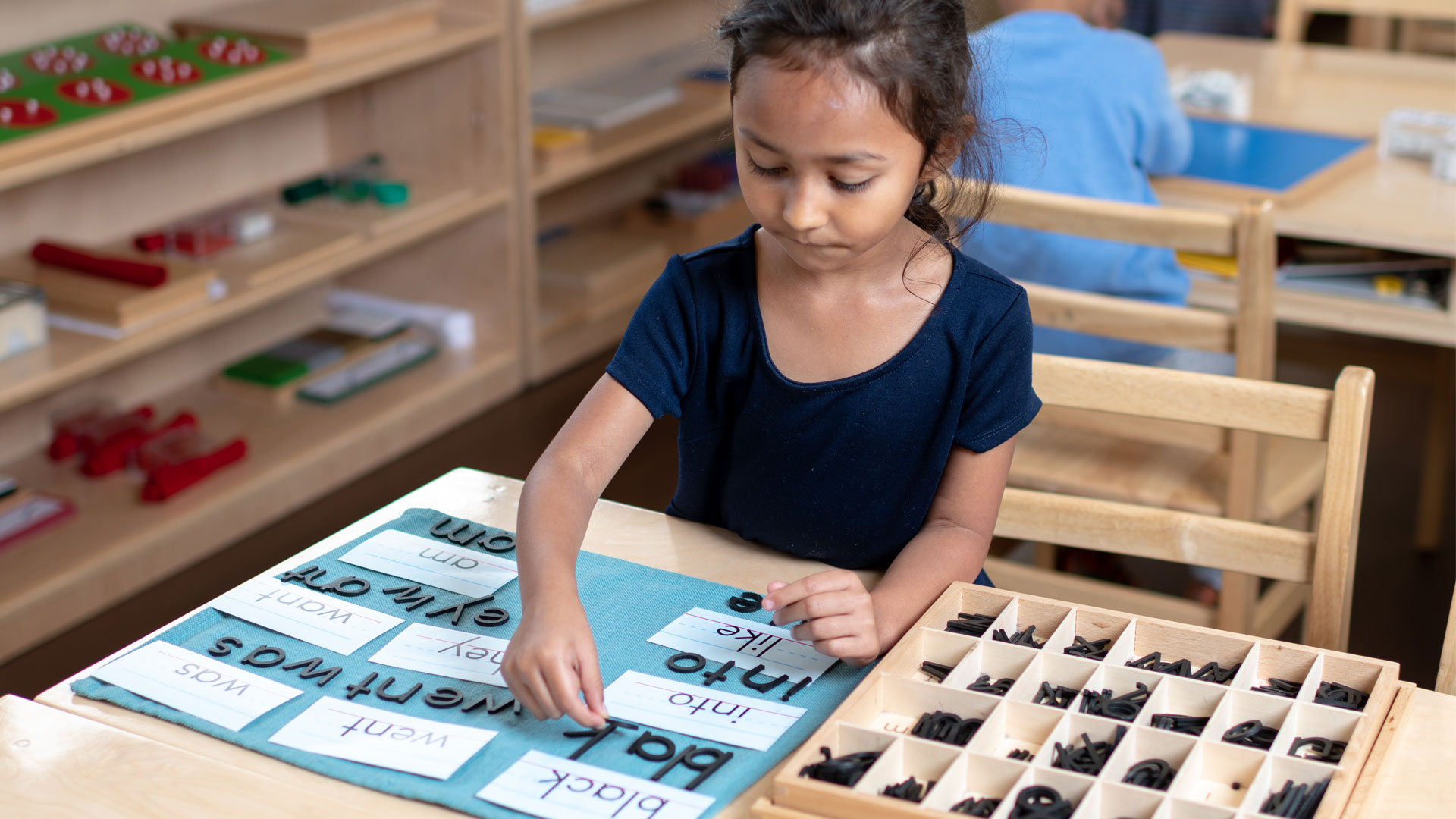 A girl playing with letters